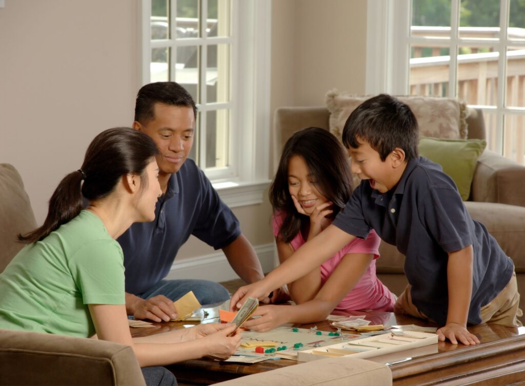 family playing board games together, positive reinforcement